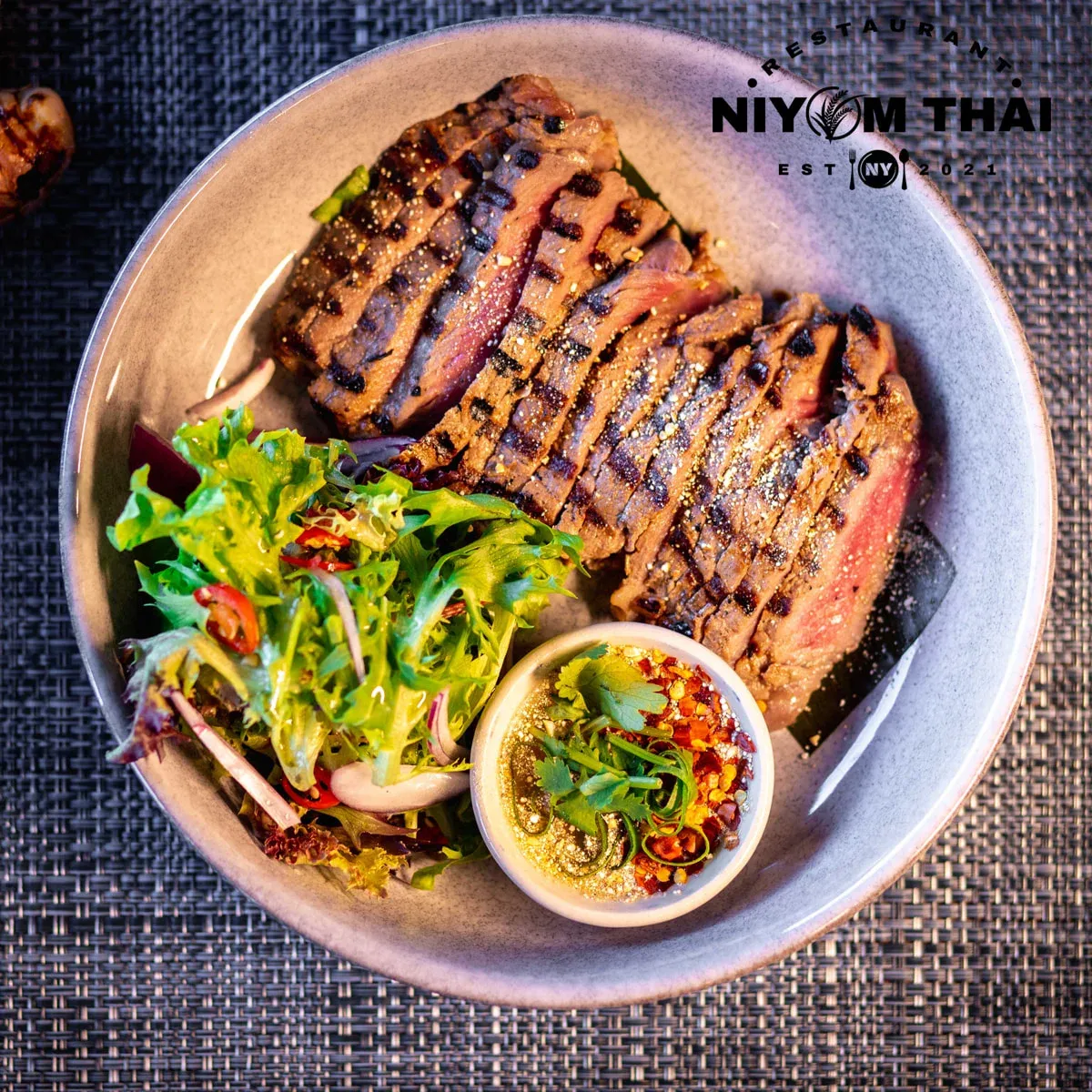Grilled beef scotch fillet with Thai sauce.