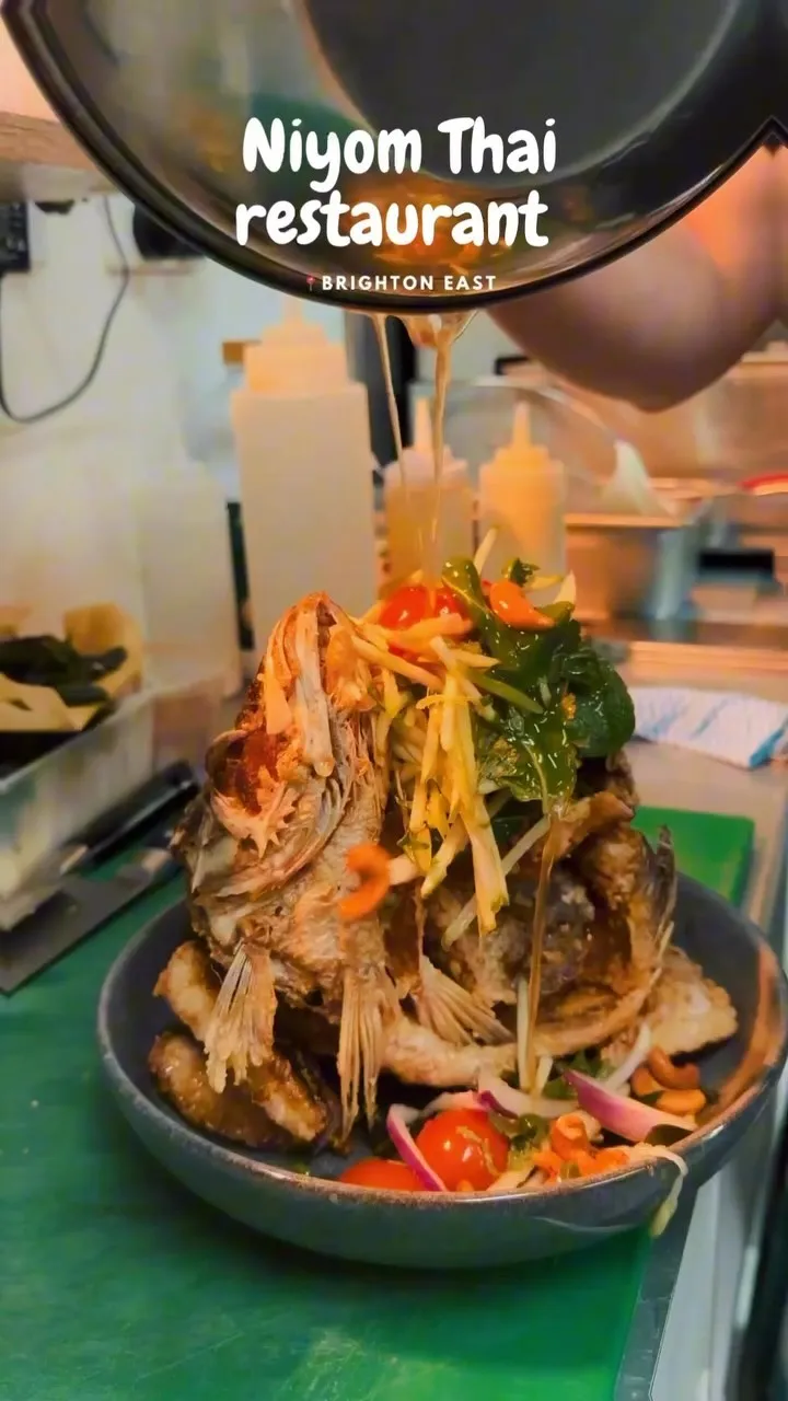 Crispy whole barramundi with green mango salad.